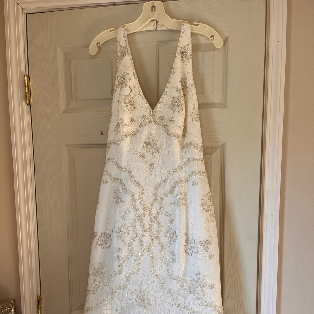 Never worn wedding dress size 12, fits like a 10